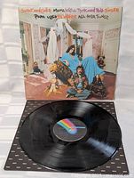 Vinyl record with MCA Records label displayed with original cover showing the album art featuring Sonny and Cher in a decorated room with lion and dolls.