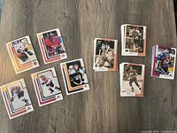 Stacks and spread of hockey trading cards showing different players and team logos from the 1999 Upper Deck series.