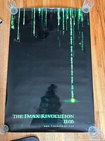 Poster showing The IMAX Revolution 11.05 with green digital rain text on black background.