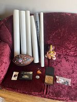 NFL memorabilia items displayed on couch include Washington Redskins doll, mini NFL football, 1998 collector's pin, Kansas City Chiefs keychain, 3 Baltimore Colts coasters, 15 NFL tacks, 6 rolled posters