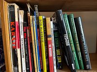 Books on shelf showing multiple sports titles focused on hockey, martial arts, and football