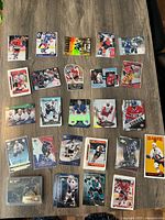 A photo showing 21 assorted Upper Deck hockey trading cards laid out on a table, featuring various players in different poses and card designs.