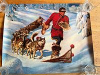 Poster of Mountie pulling a sled dog team through a snow-covered forest, holding furs and wearing fur-lined boots.