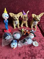 Shows all the figures including three Taco Bell dogs and four Jack in the Box figurines along with 5 antenna bubbles in packaging