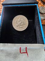 Single used 1971 US Half Dollar coin in a presentation box, reverse side showing the Great Seal of the United States.