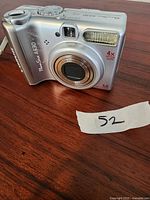 Front view of Canon PowerShot A530 digital camera showing lens, flash, and some body wear.