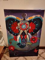 Front view of the oil painting showing the decorated elephant with bold colors and floral patterns.