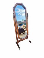 Front view of the tall, octagonal wooden frame mirror with standing base.