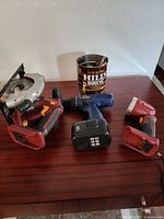 Photo showing Black & Decker circular saw, cordless drill, cordless flashlight, and coffee can with tools.