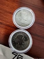 Obverse side of two Susan B. Anthony dollar coins dated 1979 and 1979-S, showing Susan B. Anthony's portrait in protective capsules.