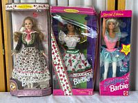 Three Barbie dolls in original boxes: Austrian Barbie, Mexican Barbie, and Tooth Fairy Barbie Special Edition