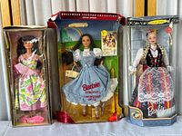 Front view of the three boxed Barbie dolls: Spring Petals on left, Dorothy Wizard of Oz center, Polish Barbie right