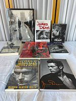 Collection of six James Dean books arranged on a white surface showing covers with photos and titles.