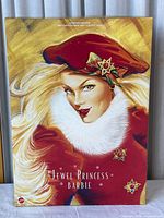 Front of box showing Jewel Princess Barbie doll Winter Princess Collection artwork with Barbie in red hat and fur collar