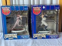 Front view of boxed Babe Ruth and Mike Schmidt figurines showing their standing poses and original packaging with visible wear.