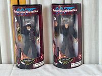 Two 007 Tomorrow Never Dies limited edition action figures in original packaging, showing figures of Elliot Carver and James Bond side by side.
