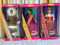 Front view of the three Barbie dolls in original boxes standing side by side, showing the Arctic, Indian, and Russian Barbies with their outfits and box designs.