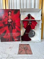 Full view of Ruby Radiance Barbie doll in box with certificate and stand