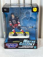 Front view of the boxed Wayne Gretzky collectible figurine from Starting Lineup series, showcasing the figurine in New York Rangers uniform inside display box with 'Final Season Commemoration' label.