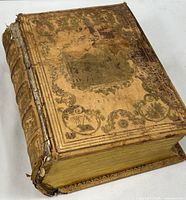 Front cover showing gilt embossed decoration and wear