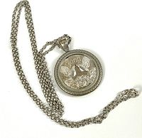 Photo of medallion on chain showing front detailed dove and roses design with 2000 date