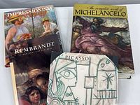 All four books arranged in a stack with covers visible.