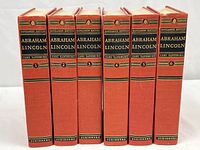 Front spines of six red hardcover Abraham Lincoln volumes by Carl Sandburg, Sangamon Edition, numbered 1 to 6.
