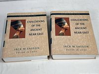 Two hardcover volumes in dust jackets, showing front covers and titles 'Civilizations of the Ancient Near East' volumes one & two and three & four edited by Jack M. Sasson.