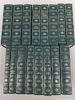 Photo showing all 16 volumes of The Programmed Classics collection, green hardcover books with gold embossed titles and decorations on spine.