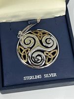 Sterling silver and gold-tone Celtic design pendant in original blue box labeled 'STERLING SILVER'