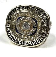 Close-up of the ring top showing Chicago Bears logo with faux diamonds and 'WORLD CHAMPIONS' text.