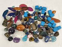 Full view of all assorted polished mineral specimens showing variety of shapes, colors, and sizes.