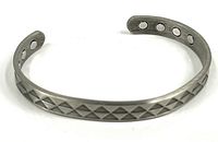 Front view of copper cuff bracelet showing four embedded magnets on the inside and geometric patterned outside surface