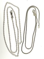 Two sterling silver chains displayed fully extended to show length and design, one twisted rope style and one flat link style.