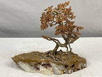 Full view of vintage Mid Century Modern bonsai tree sculpture showing metal trunk and roots with citrine stone blossoms on natural onyx slab base