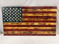 Full view of wooden American flag wall art showing stars and stripes with rustic stained wood finish.