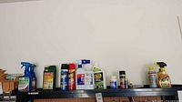 Wide view of all garden sprays, insecticides, cleaners, and lubricant bottles.