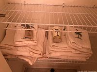 Set of towels stacked on a wire rack showing design and quantity