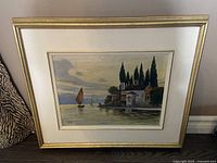 Front view of the framed oil painting depicting Lake Como, Italy with a church and boats on the lake under a dusk sky.