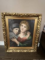 Front view of the oil painting showing two figures in framed artwork.