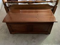 Closed view of wooden blanket box with visible surface wear and rustic finish.