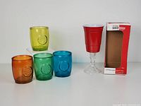 Four colored San Miguel recycled glass cups and one Rednek party wine glass with original box