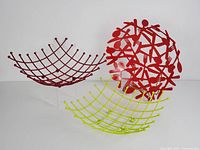 Three wire fruit baskets, one red solid cutout design and two lattice wire design in red and lime green