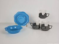 Two blue Pyrex Cornflower pattern bowls displayed, 1 standing on stand and 1 flat