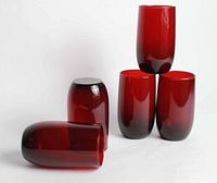 Five vintage ruby red glasses stacked and arranged to show color and shape.