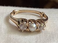 Front view showing pearl center flanked by two diamonds