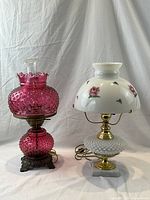 Photo showing two table lamps side by side on a plain background.