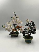 Front view of both bonsai tree sculptures side by side on neutral background