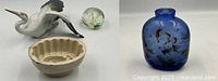 All four items displayed together showing the blue heron figurine, paperweight, pineapple mold, and small blue floral bottle