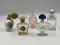 Group photo of all five perfume bottles showing varying styles and design features